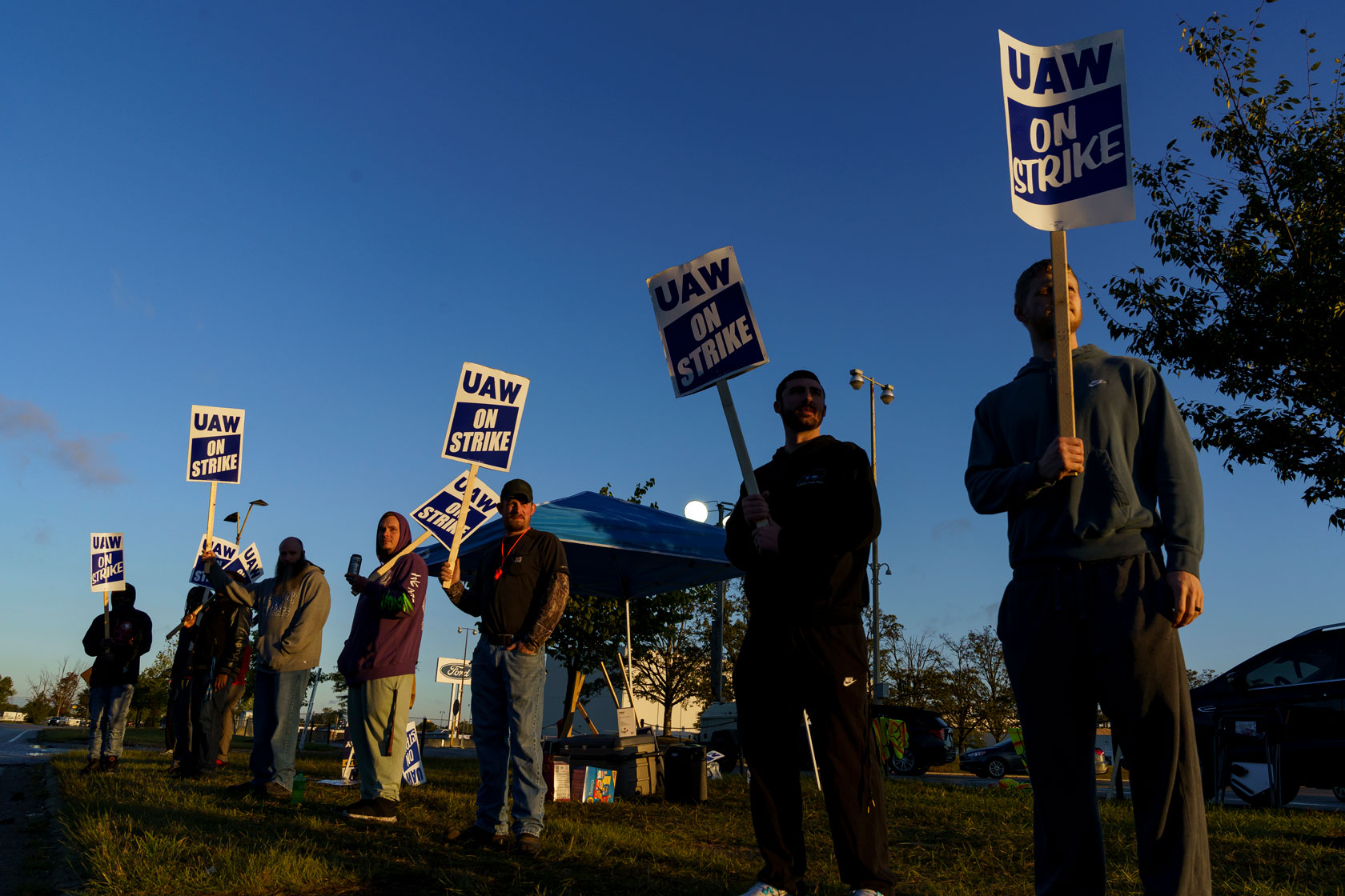 Factory workers and United Auto Workers union members hold signs while on strike in Louisville, Kentucky.