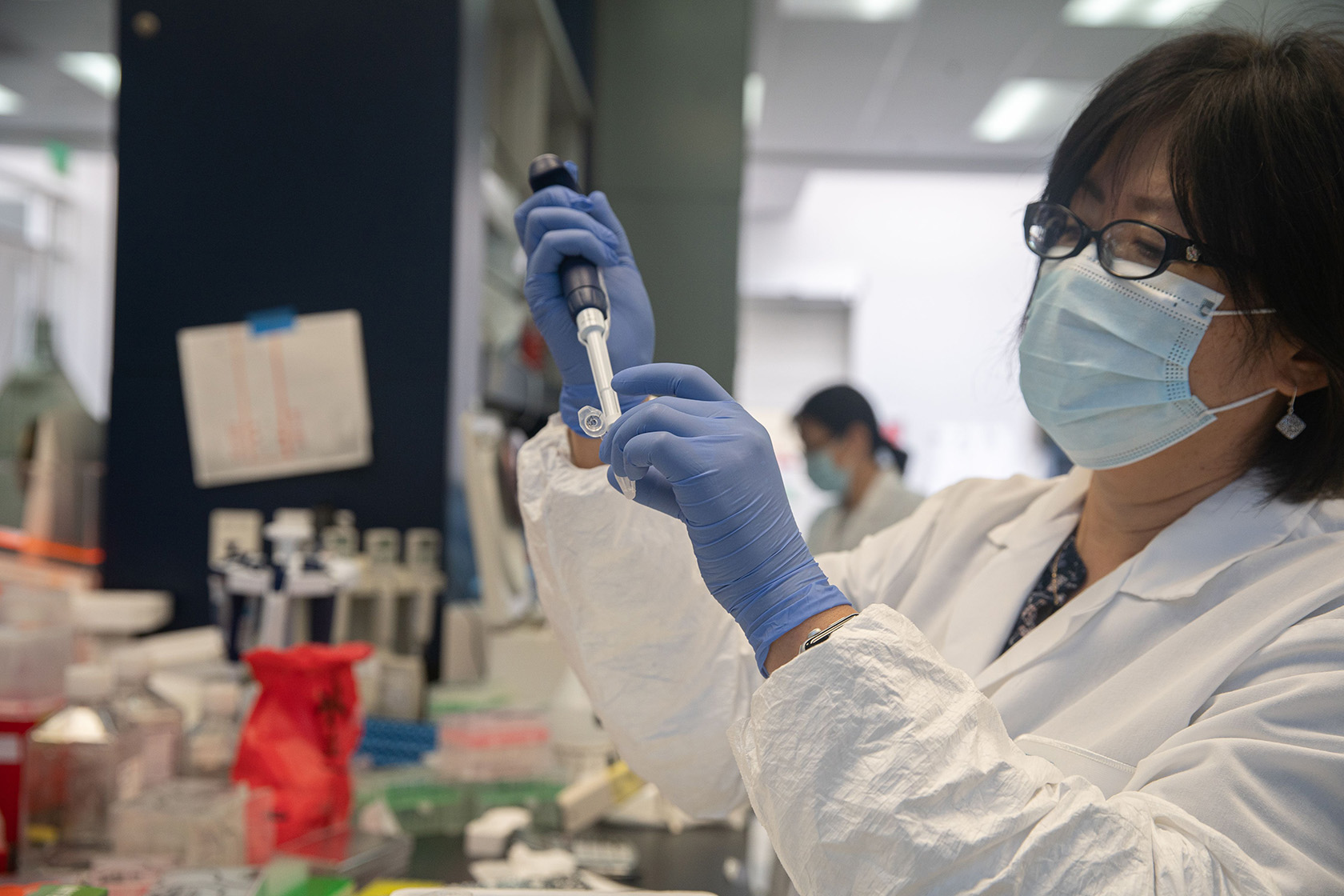 Researchers at a biopharmaceutical company conduct lab tests.