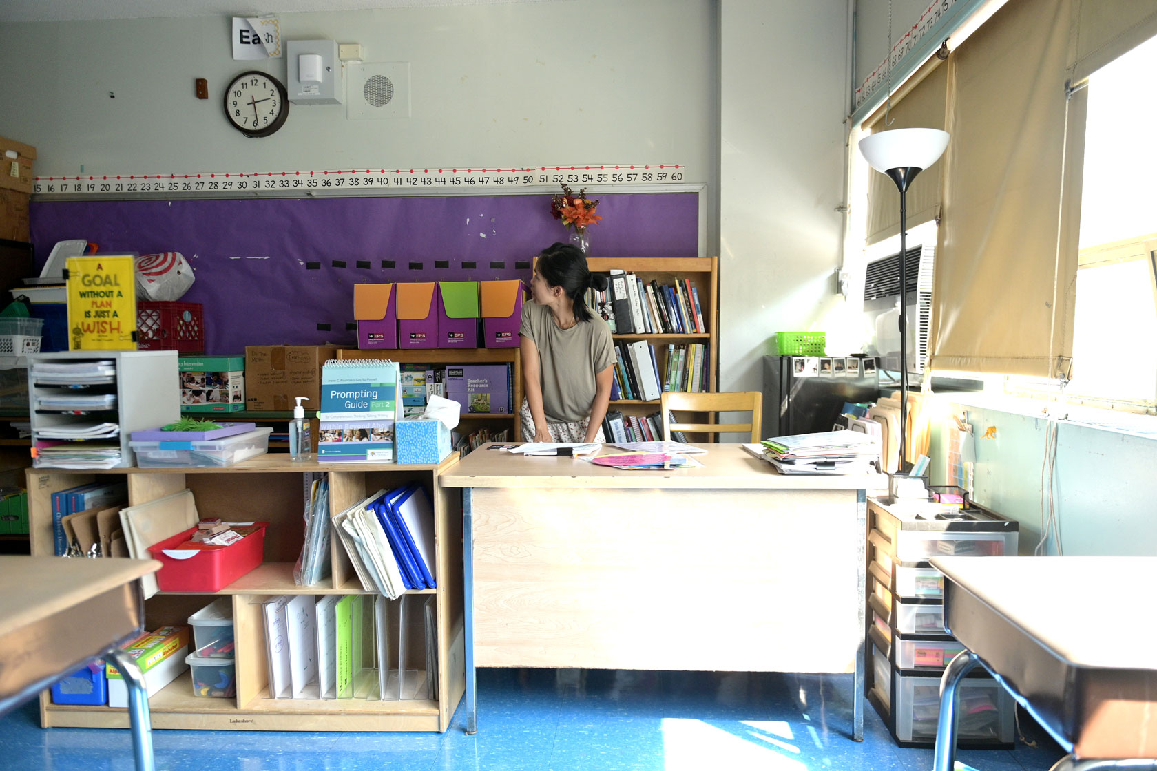 A teacher prepares her classroom for the start of the school year in New York City.