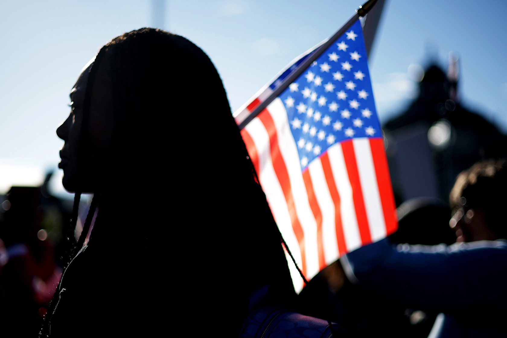 An activist holds a U.S. flag during a rally in front of the Supreme Court.