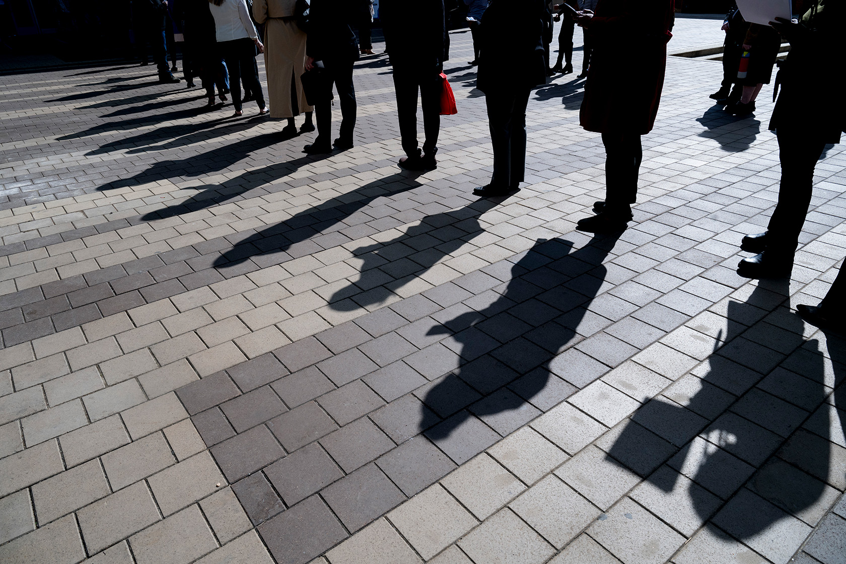 Job seekers wait in line to enter a job fair in Silver Spring.
