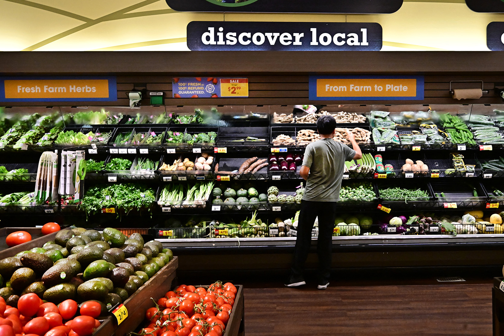 A man shops for produce at a supermarket in California.