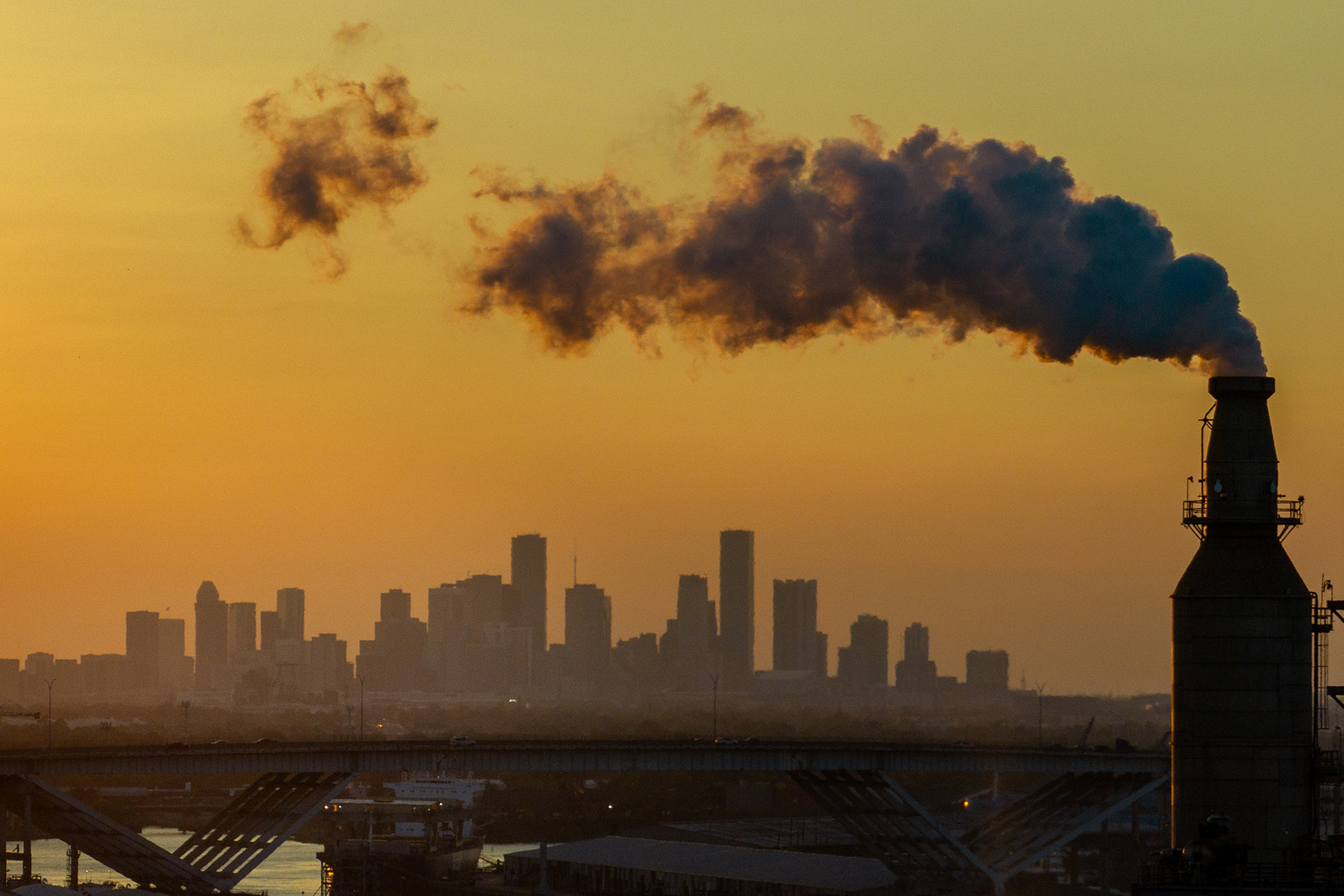 The Houston skyline is seen from an oil refinery.