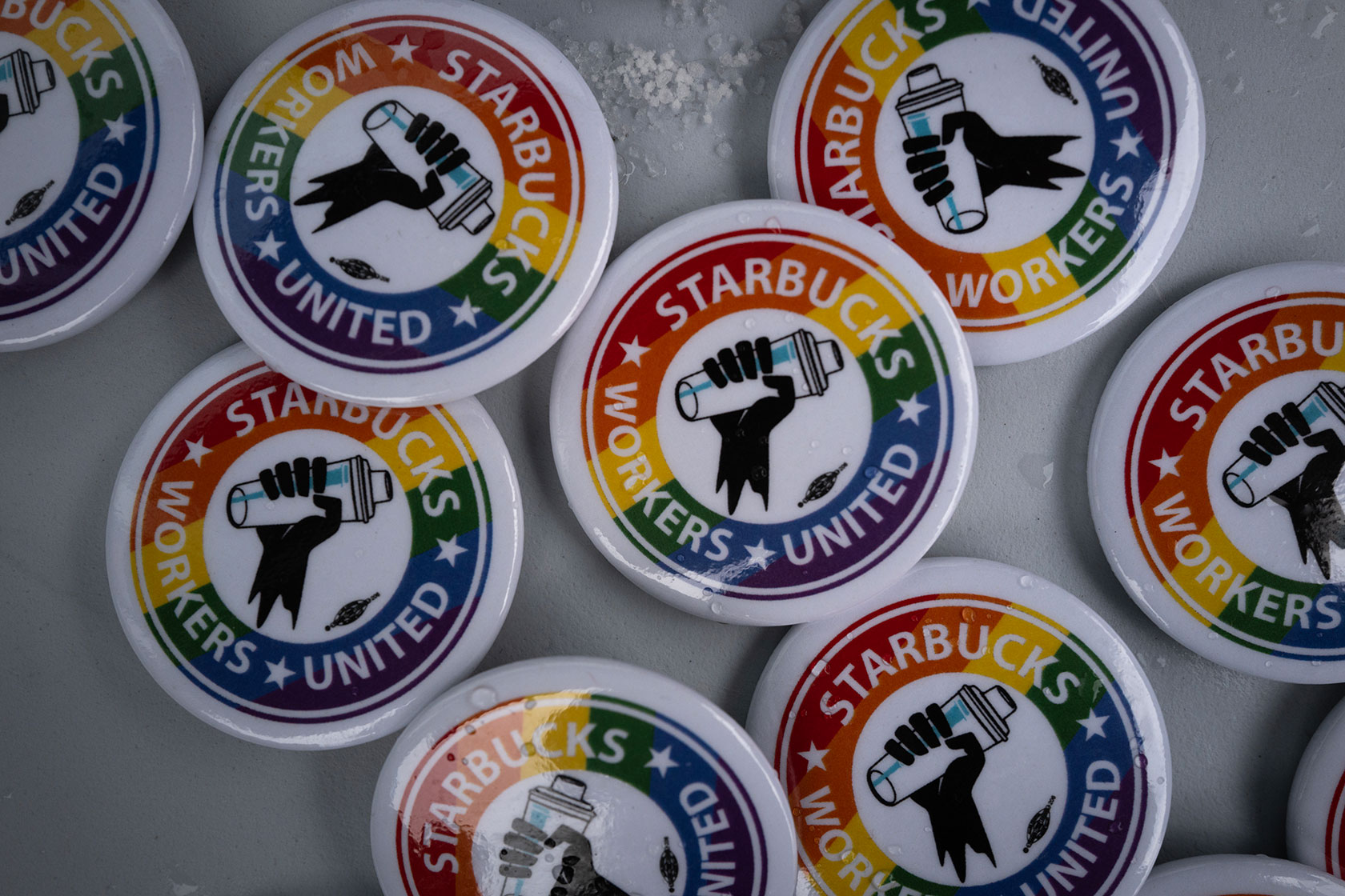 Buttons read Starbucks workers united and have logo and rainbow coloring