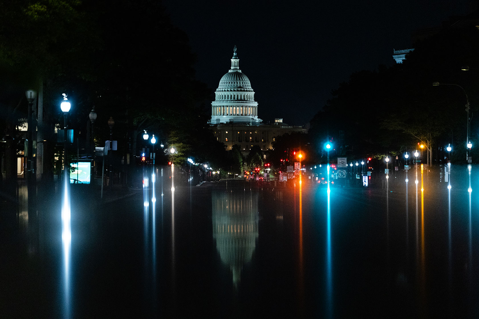 U.S. Capitol at night with various lights