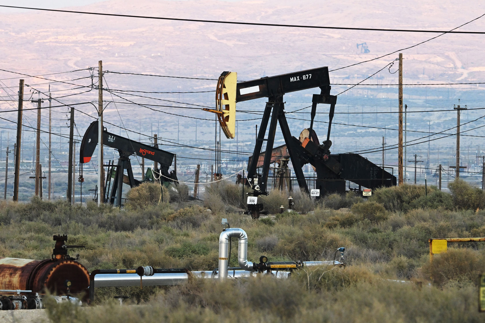 Pumpjacks lift oil from wells at an oil field near Taft, California, on October 17, 2025.