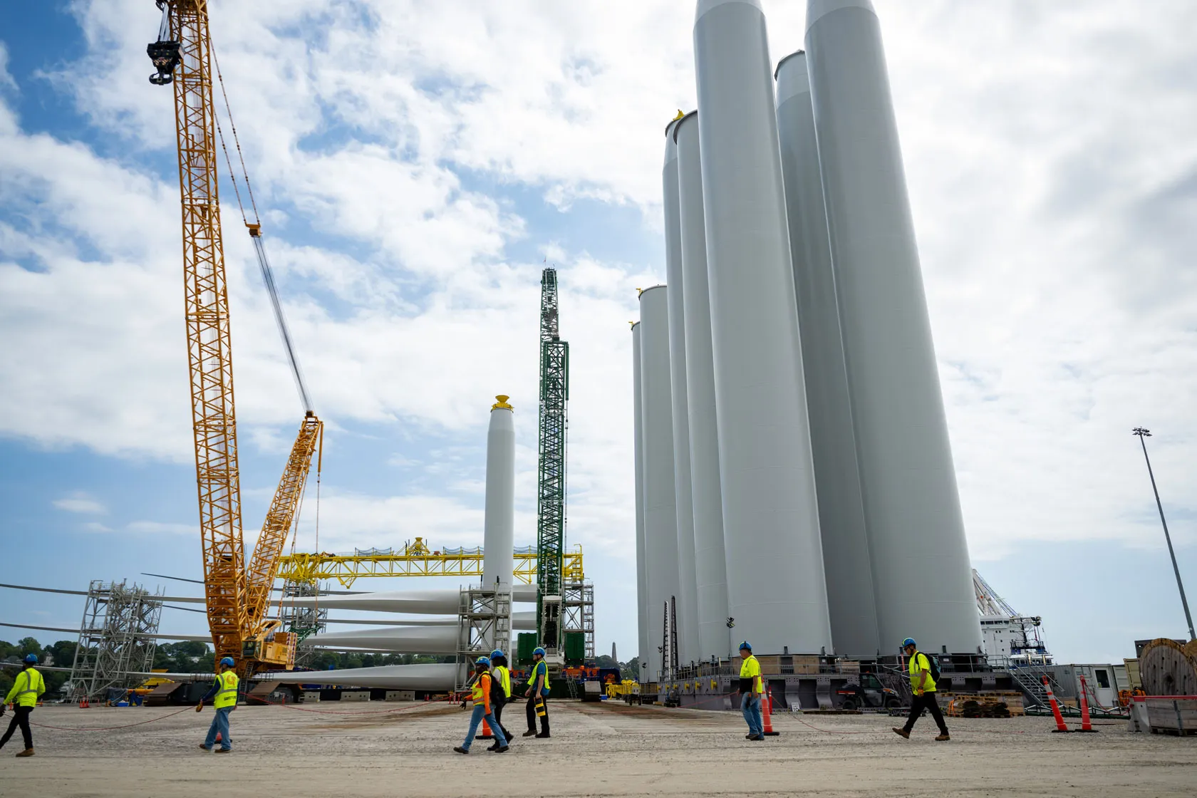 Workers walk past the construction site of an offshore wind project in New London, Connecticut, on August 25, 2025.