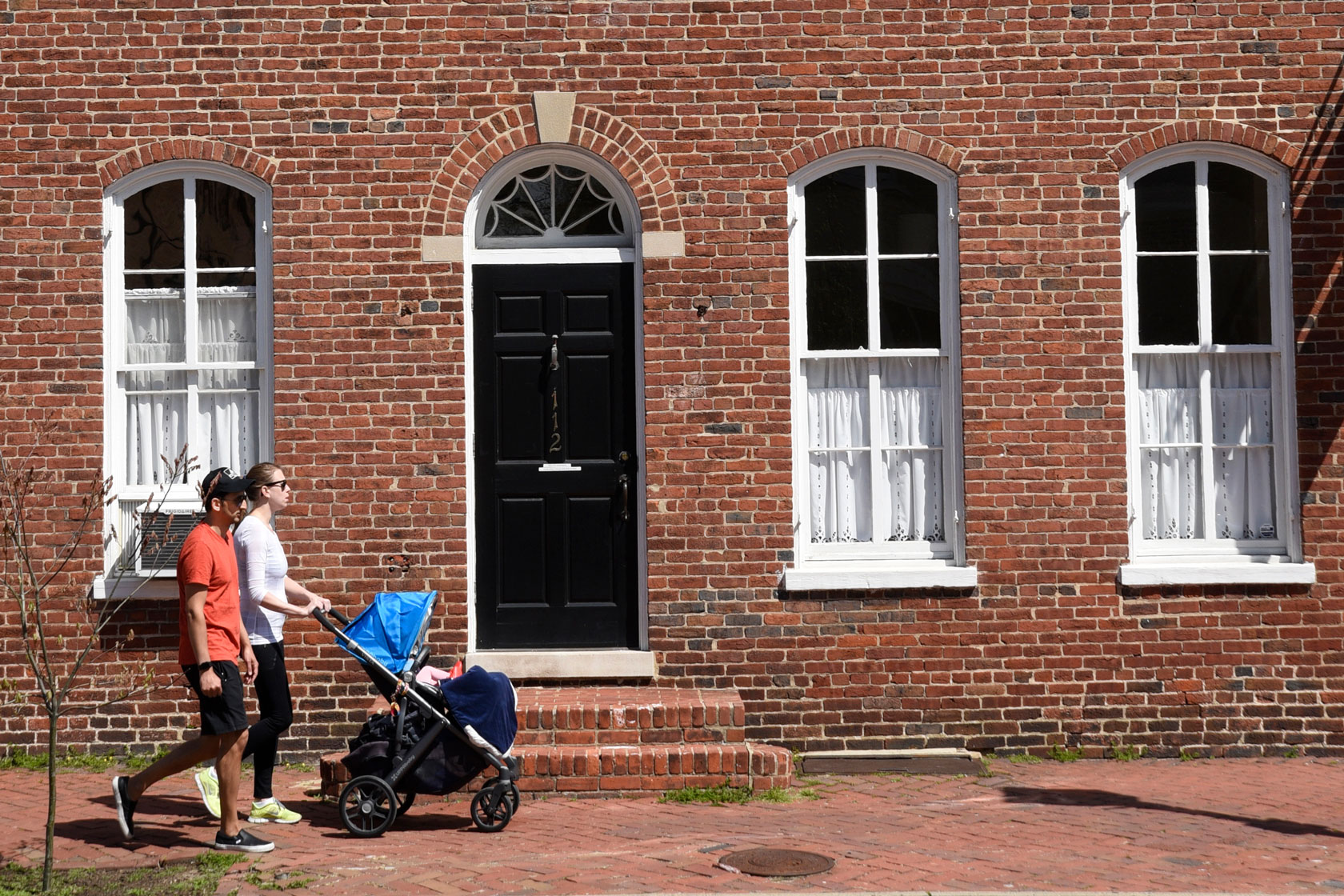 A family walks down the street in Alexandria, Virginia, on April 21, 2018.