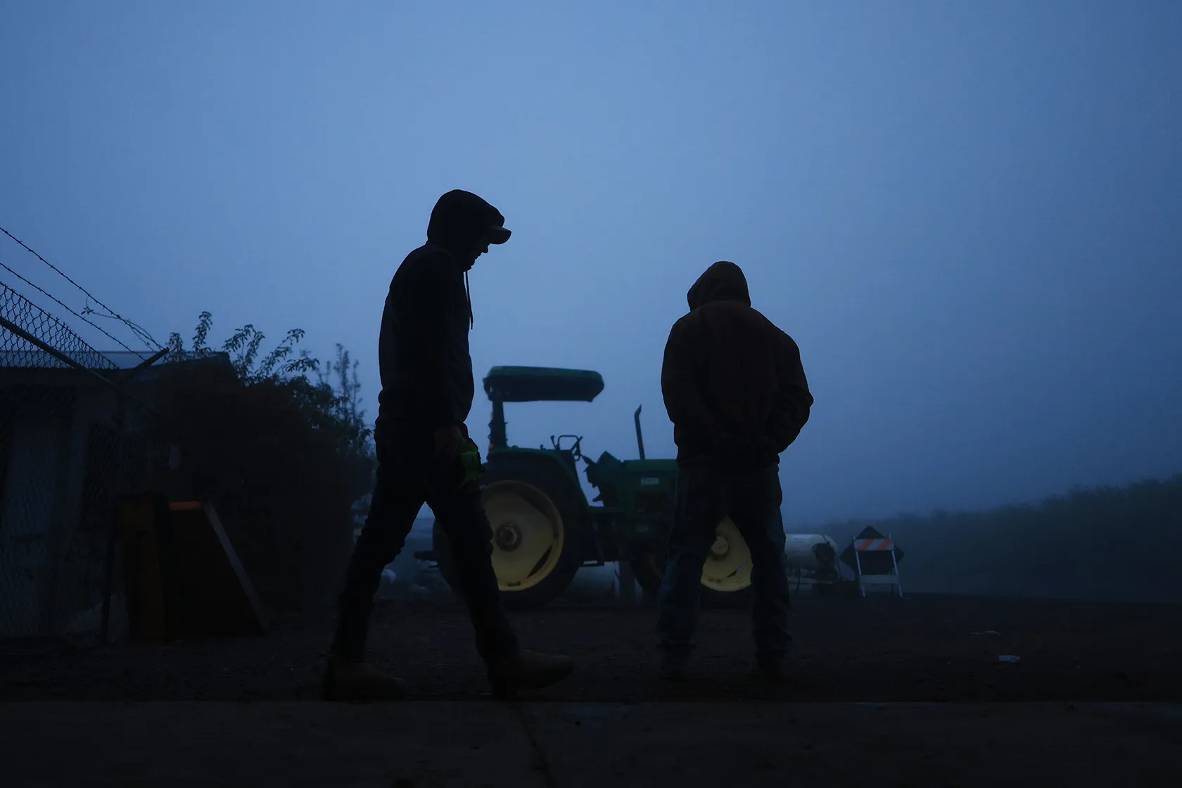 Two immigrant workers get ready for their day.