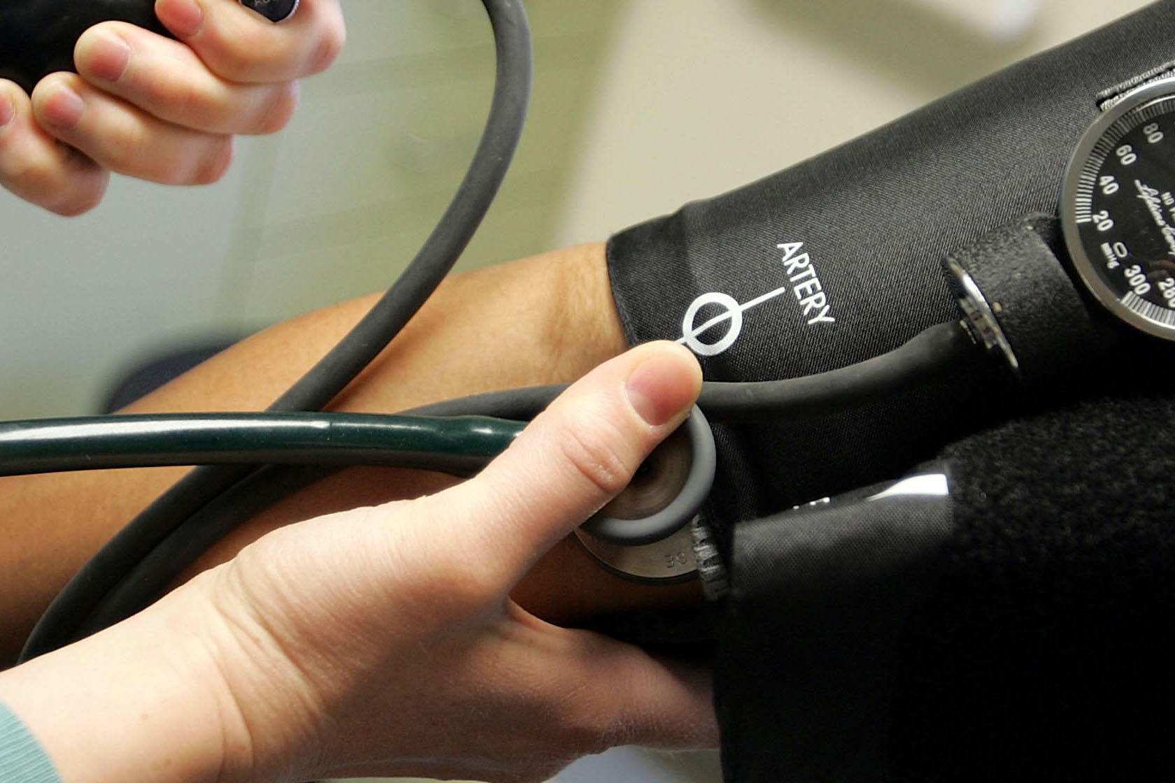 A doctor takes a patient's blood pressure