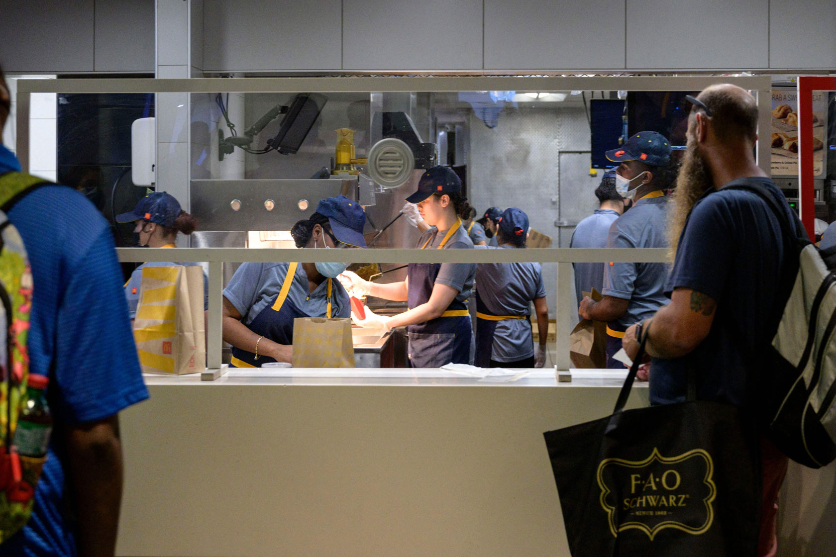 Workers behind a fast-food counter.