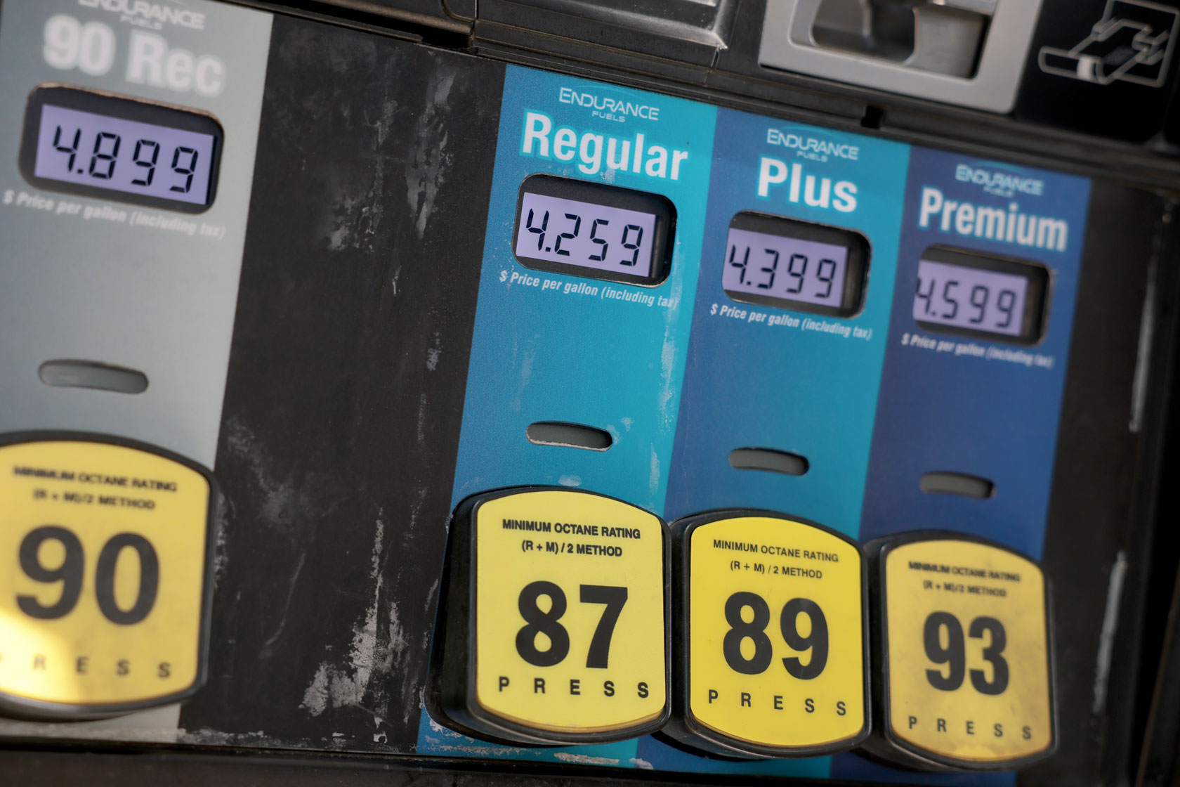 A closeup of a gas pump shows prices at higher than $4 per gallon.