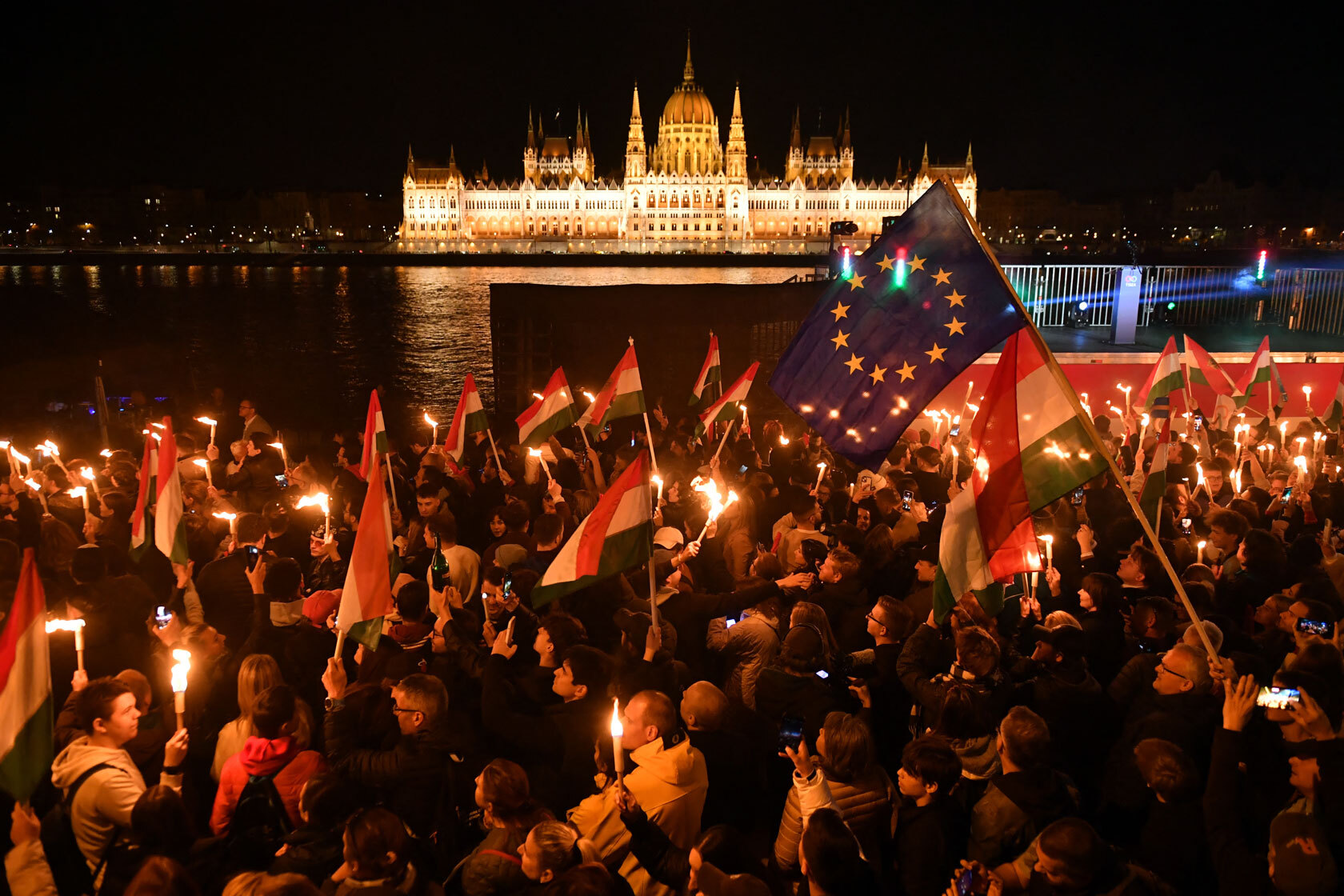 Supporters celebrate during election night on the banks on the river.