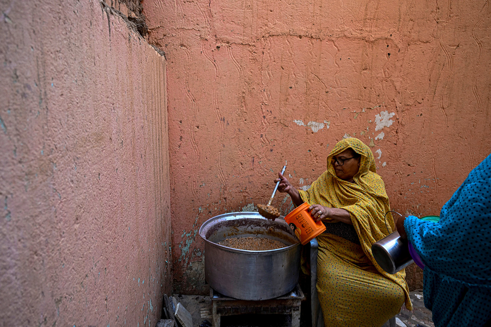 A Sudanese woman prepares a free meal in Omdurman.