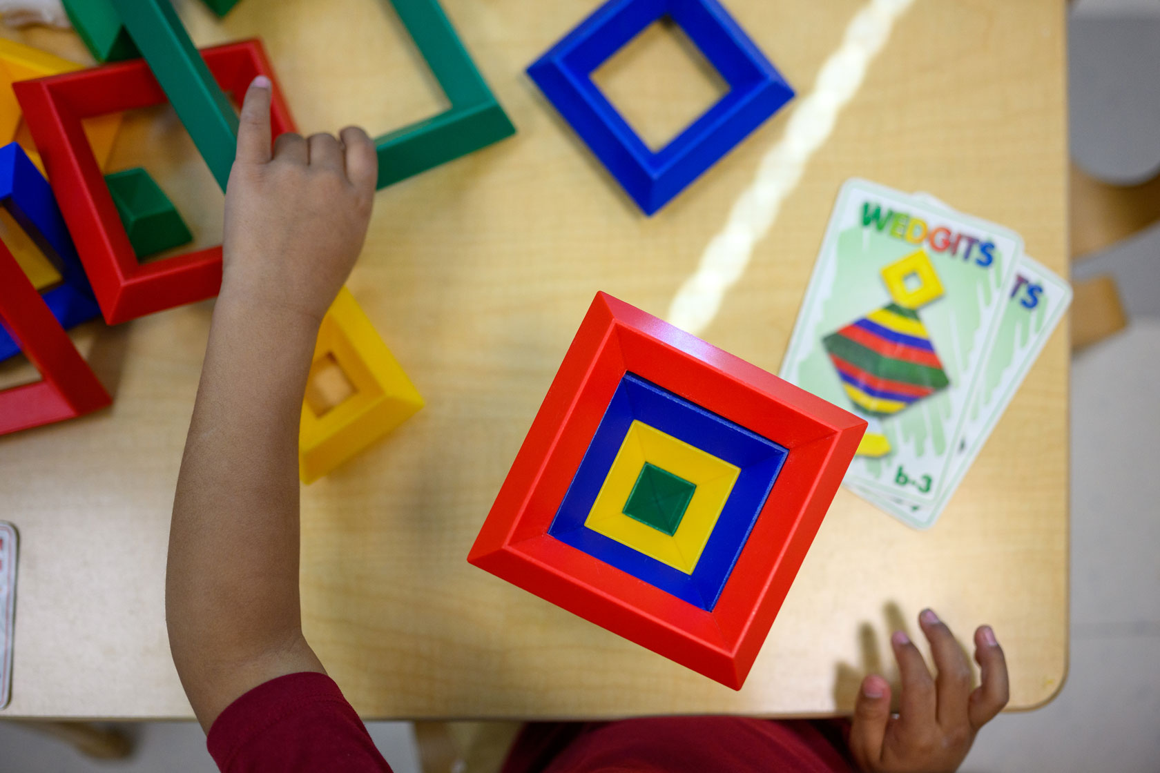 A child is seen playing with toys at the Connecticut State University Early Learning Center.