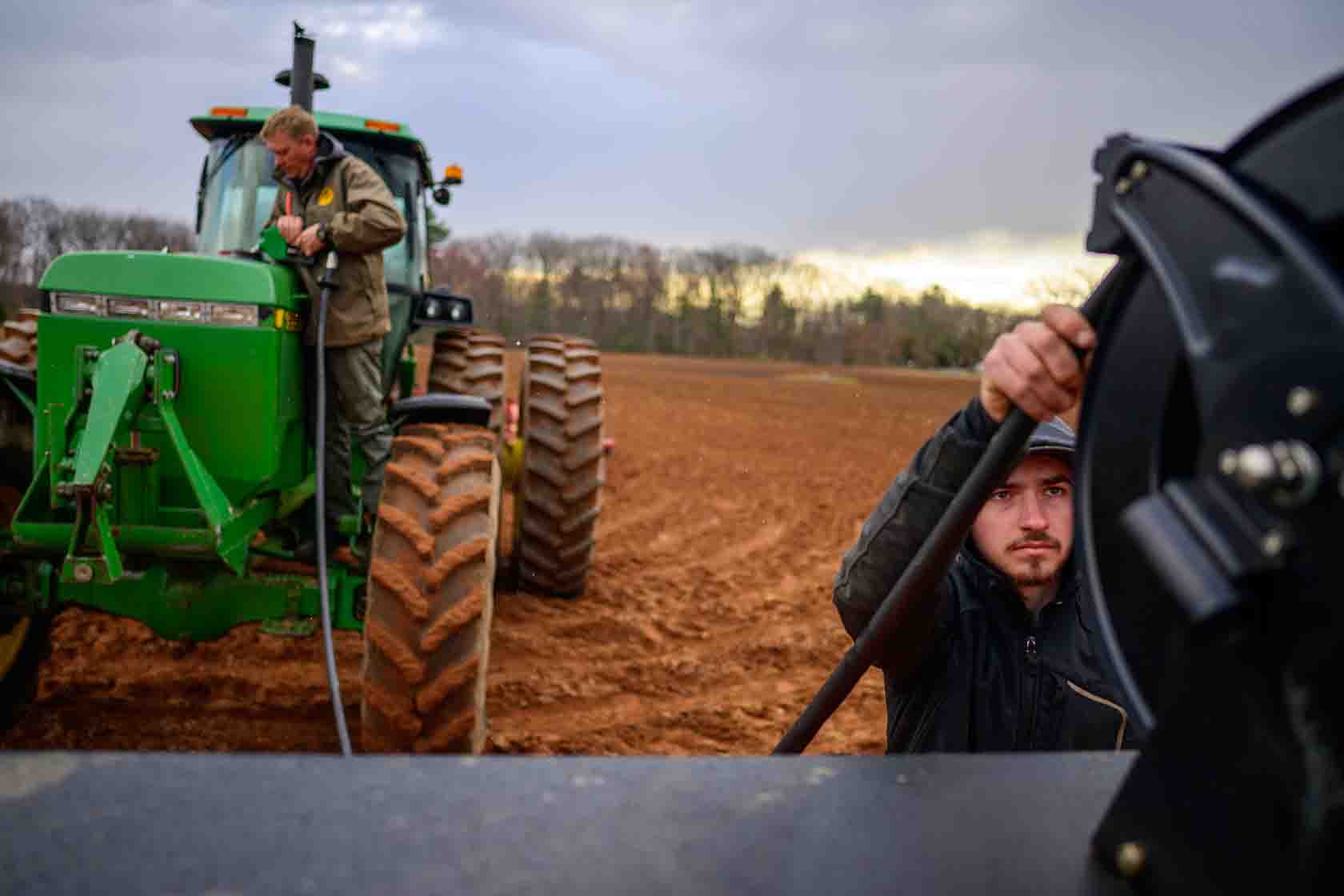 A farmer fuels a tractor in Connecticut.