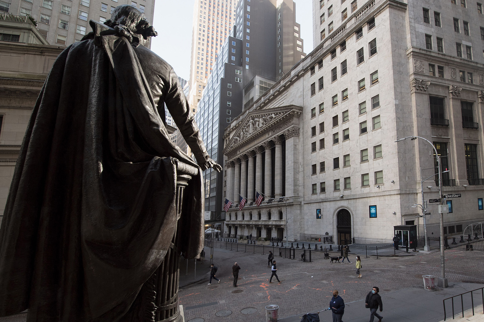 People walk past the New York Stock Exchange.