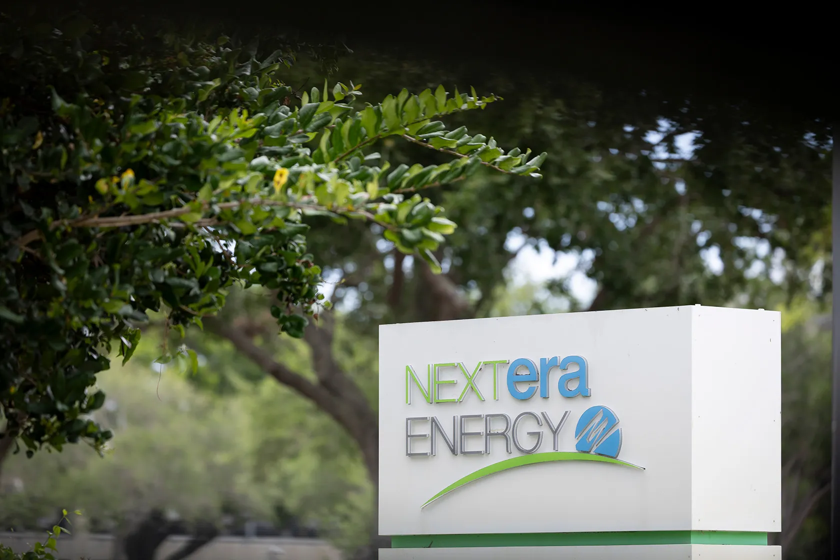 The logo of NextEra Energy is seen at the entrance of its headquarters.