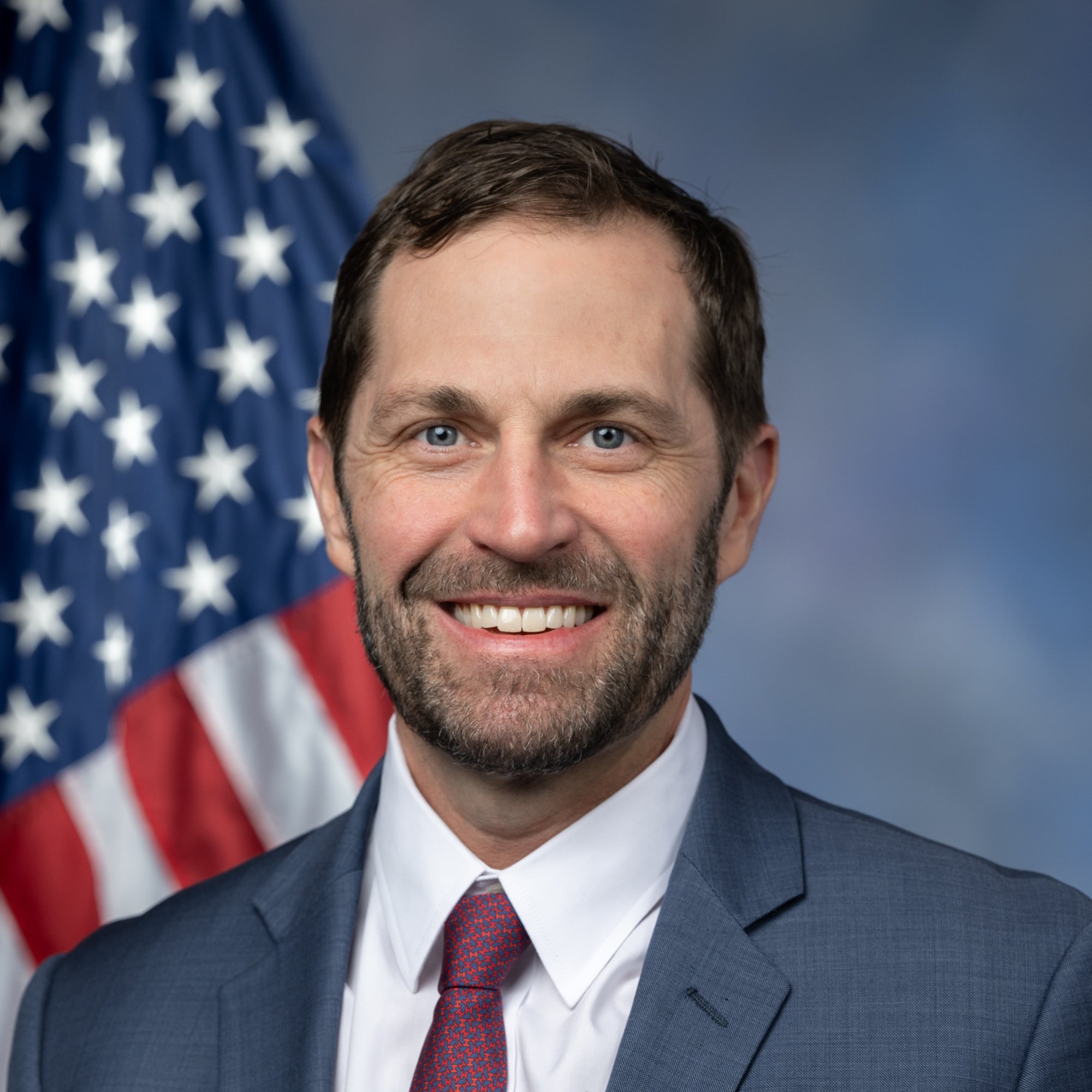 Official headshot of Rep. Jason Crow