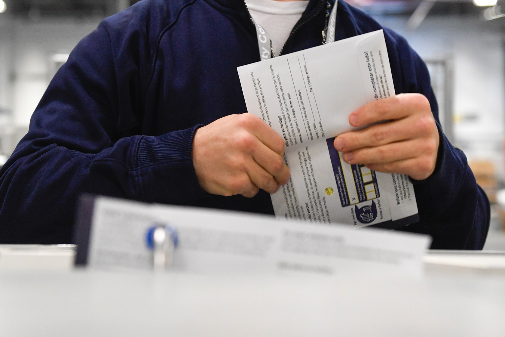 A poll worker demonstrates how ballots are received, processed, scanned, and securely stored on October 25, 2024 in Philadelphia.